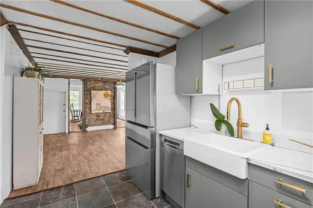 a kitchen with a refrigerator and a sink