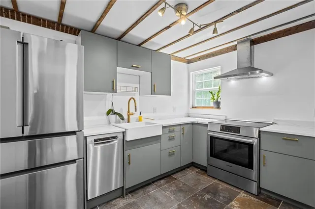 a kitchen with a sink stainless steel appliances and cabinets