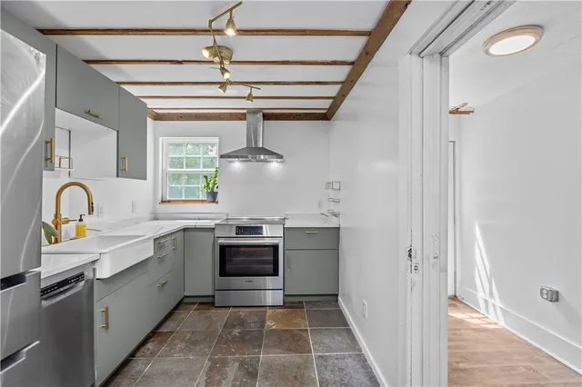 a kitchen with stainless steel appliances granite countertop a sink and a stove