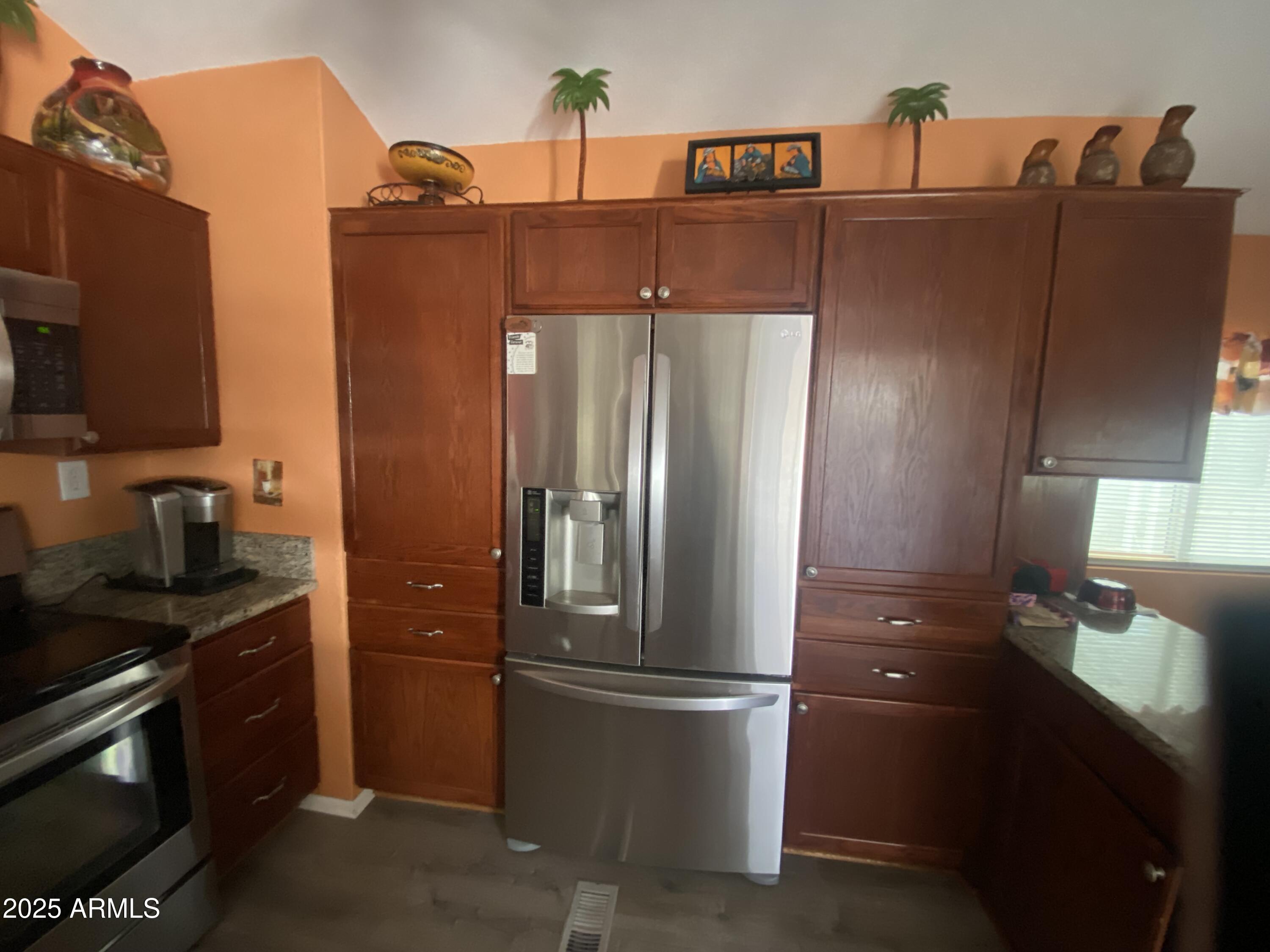 2209 West Klamath Avenue Apache Junction, AZ 85119 - Photo 13 of 30 a kitchen with stainless steel appliances granite countertop a refrigerator and a stove