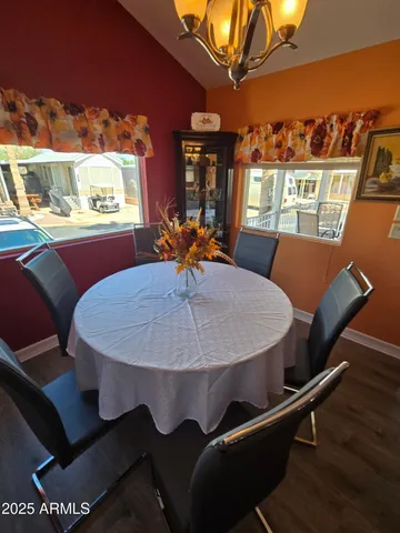 a dining room with furniture a window and wooden floor