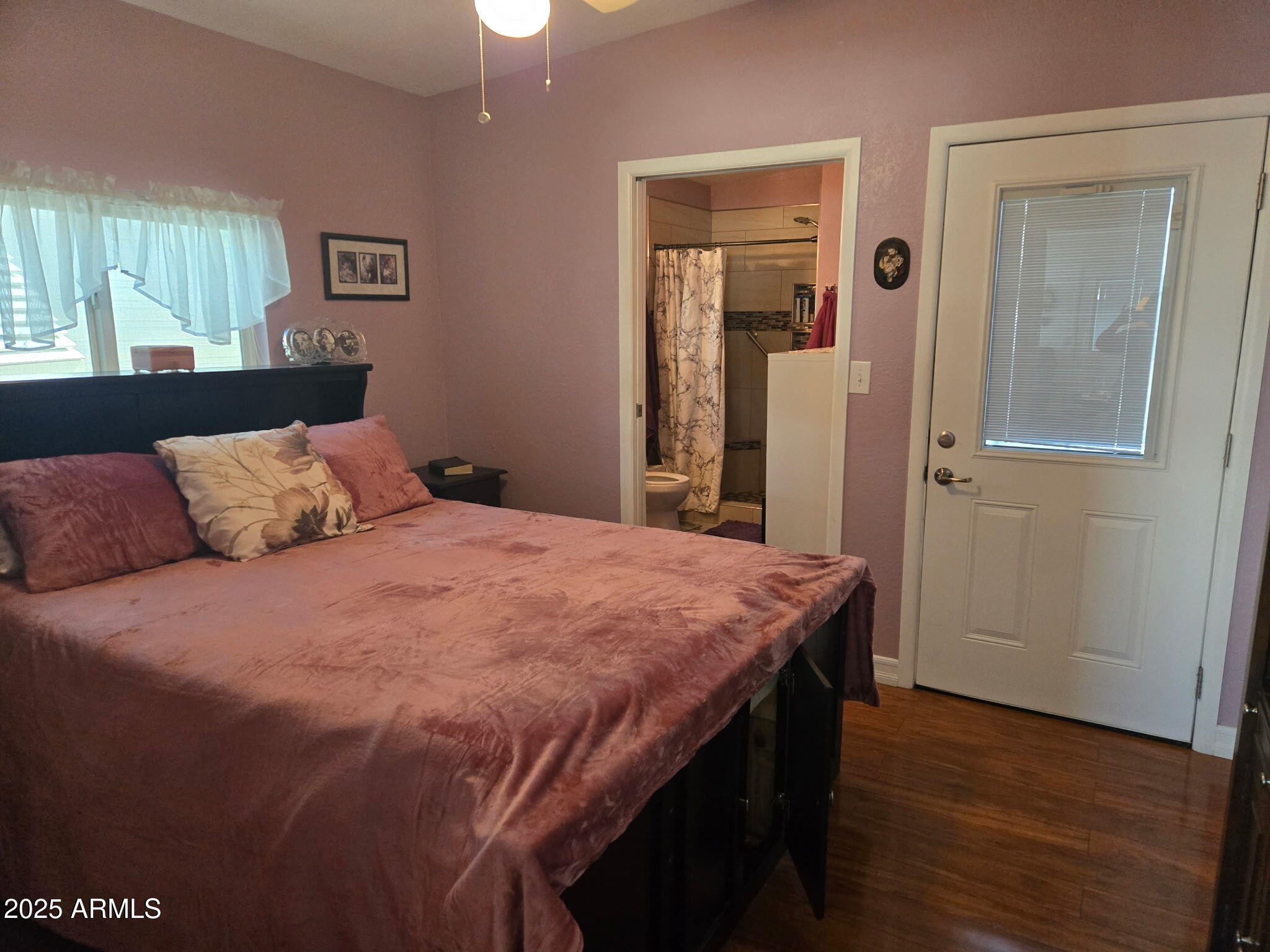 2209 West Klamath Avenue Apache Junction, AZ 85119 - Photo 19 of 30 a bedroom with a bed and wooden floor