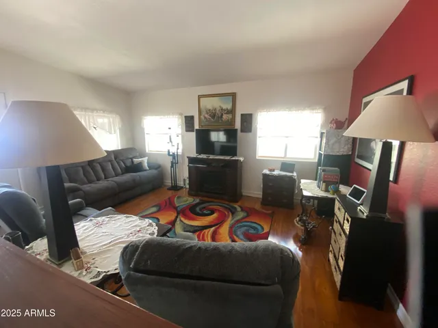 a living room with furniture a lamp and a window