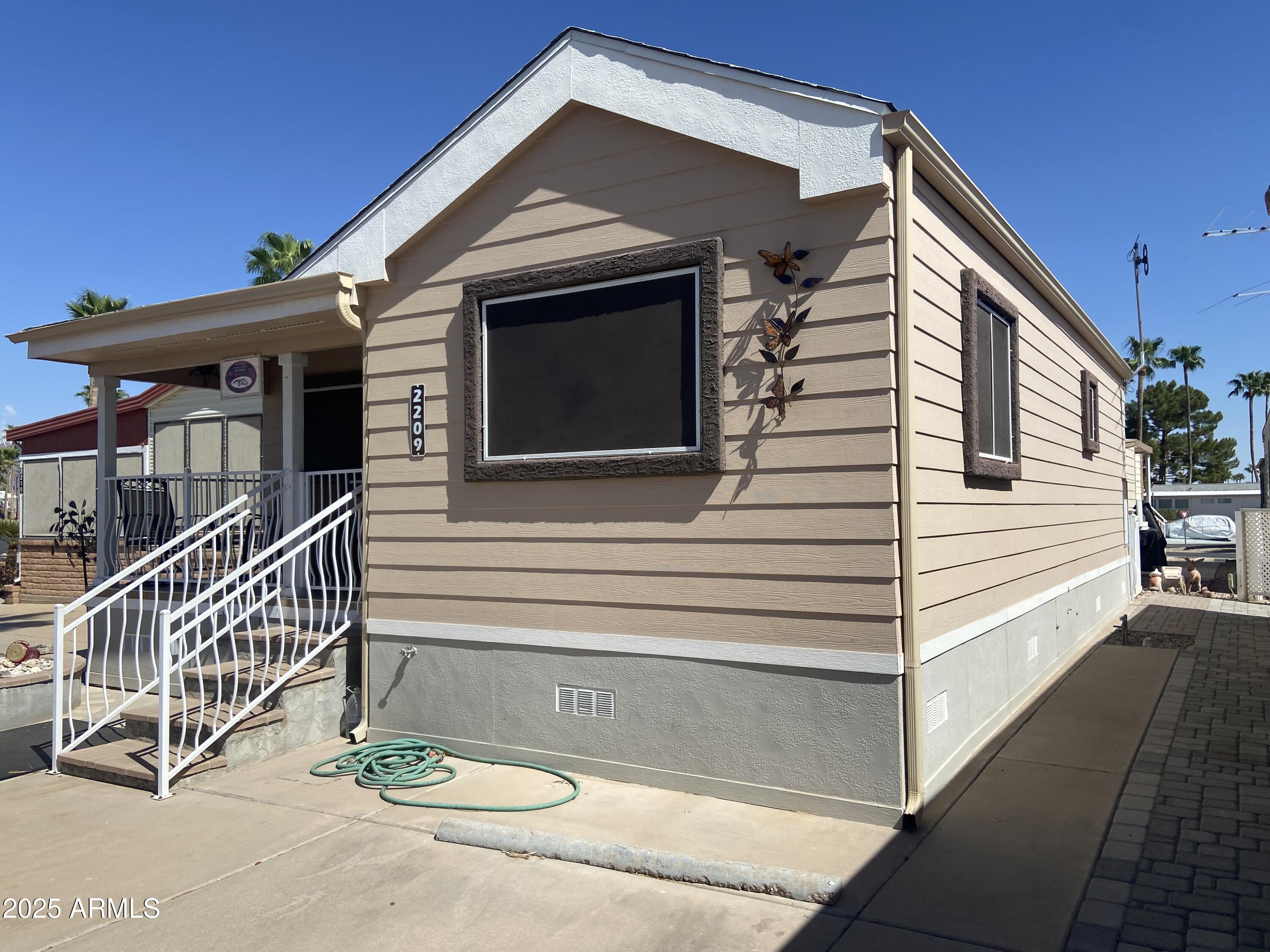 2209 West Klamath Avenue Apache Junction, AZ 85119 - Photo 27 of 30 a view of house with a yard and balcony