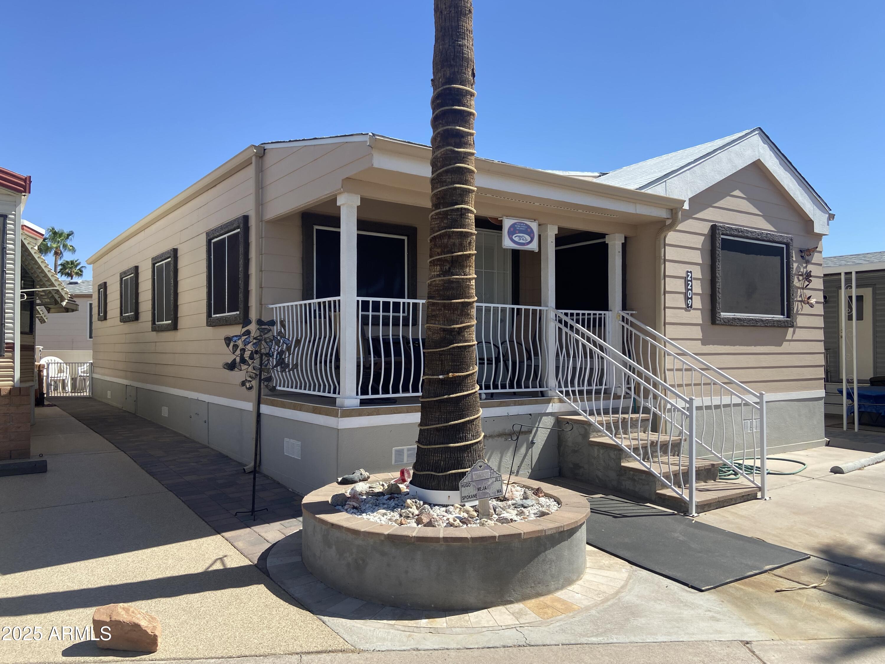 2209 West Klamath Avenue Apache Junction, AZ 85119 - Photo 29 of 30 a front view of a house with a yard