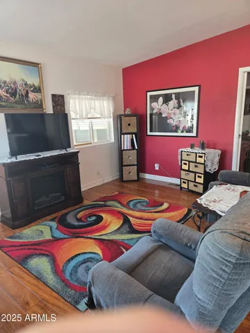 a bedroom with furniture and a wooden floor