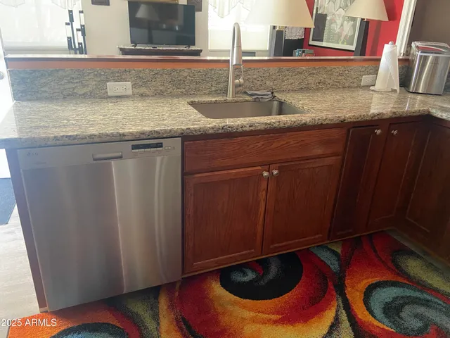 a kitchen with a sink and a mirror