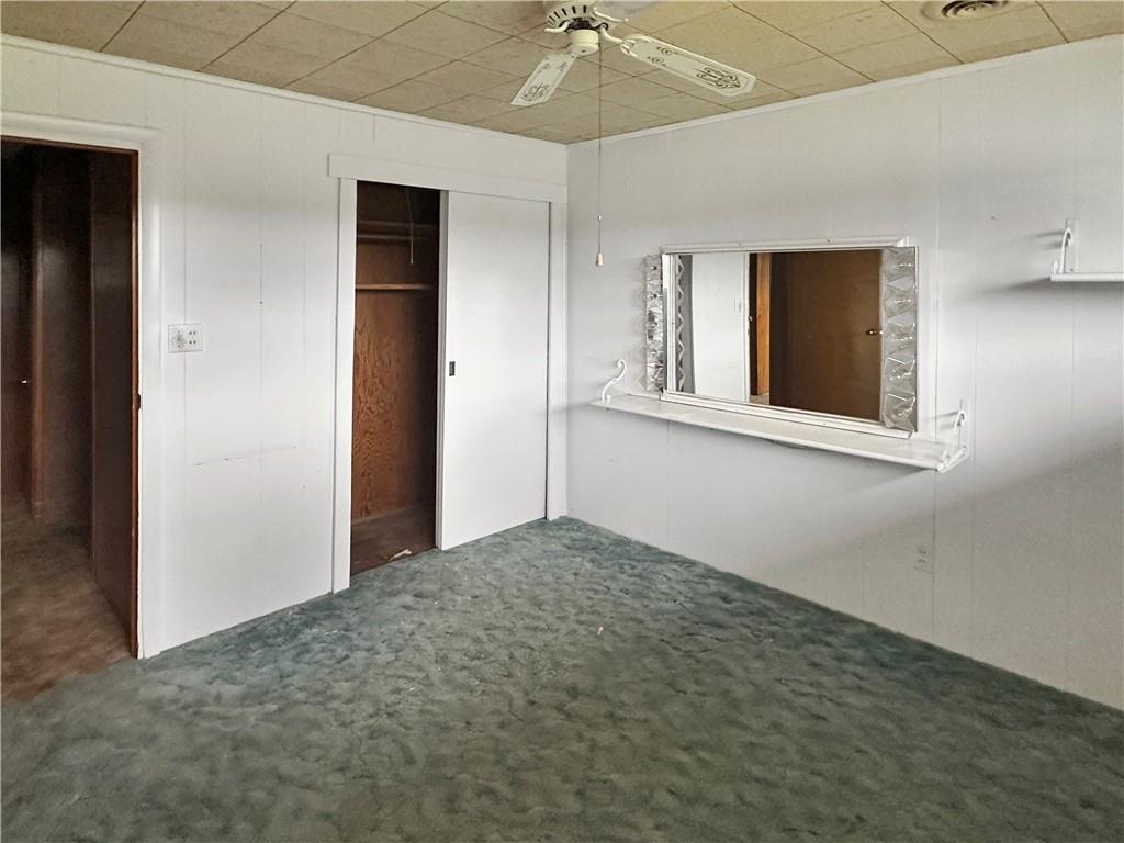 346 North Eighty Eight Road Carmichaels, PA 15320 - Photo 10 of 13 an empty room with a chandelier fan and windows