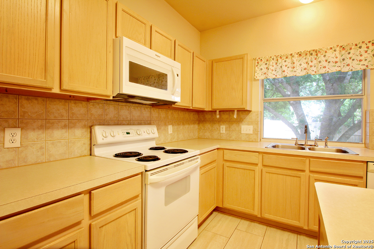 2703 Rio Brazos San Antonio, TX 78259 - Photo 15 of 34 a kitchen with stainless steel appliances granite countertop a sink and a stove
