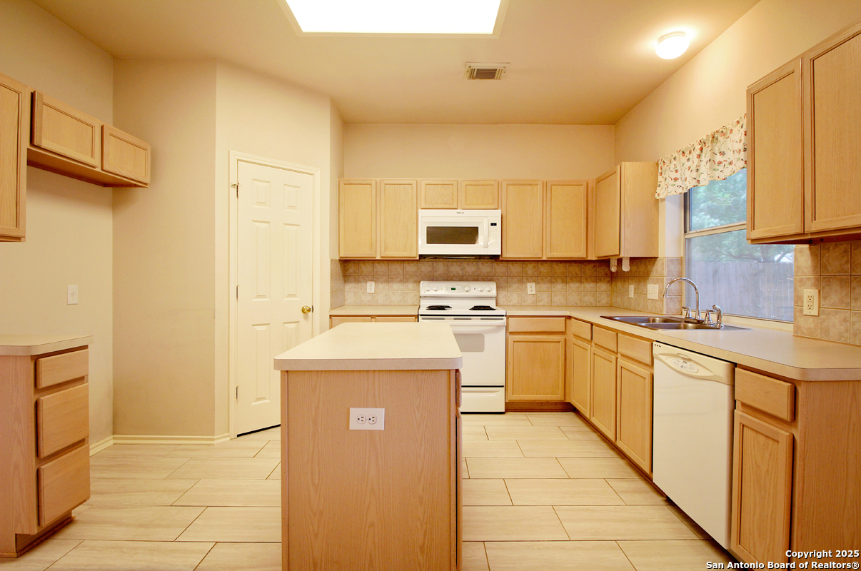 2703 Rio Brazos San Antonio, TX 78259 - Photo 17 of 34 a kitchen with stainless steel appliances a sink stove and cabinets