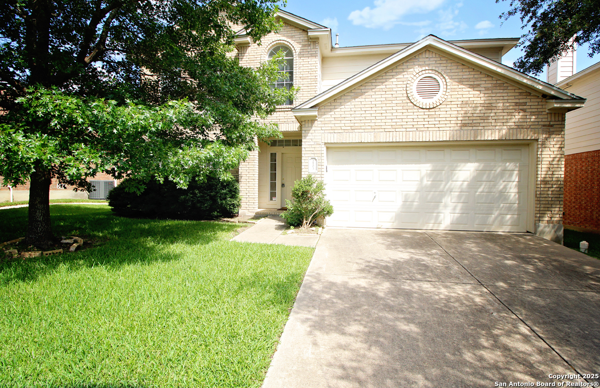 2703 Rio Brazos San Antonio, TX 78259 - Photo 2 of 34 a view of a house with a small yard and a large tree