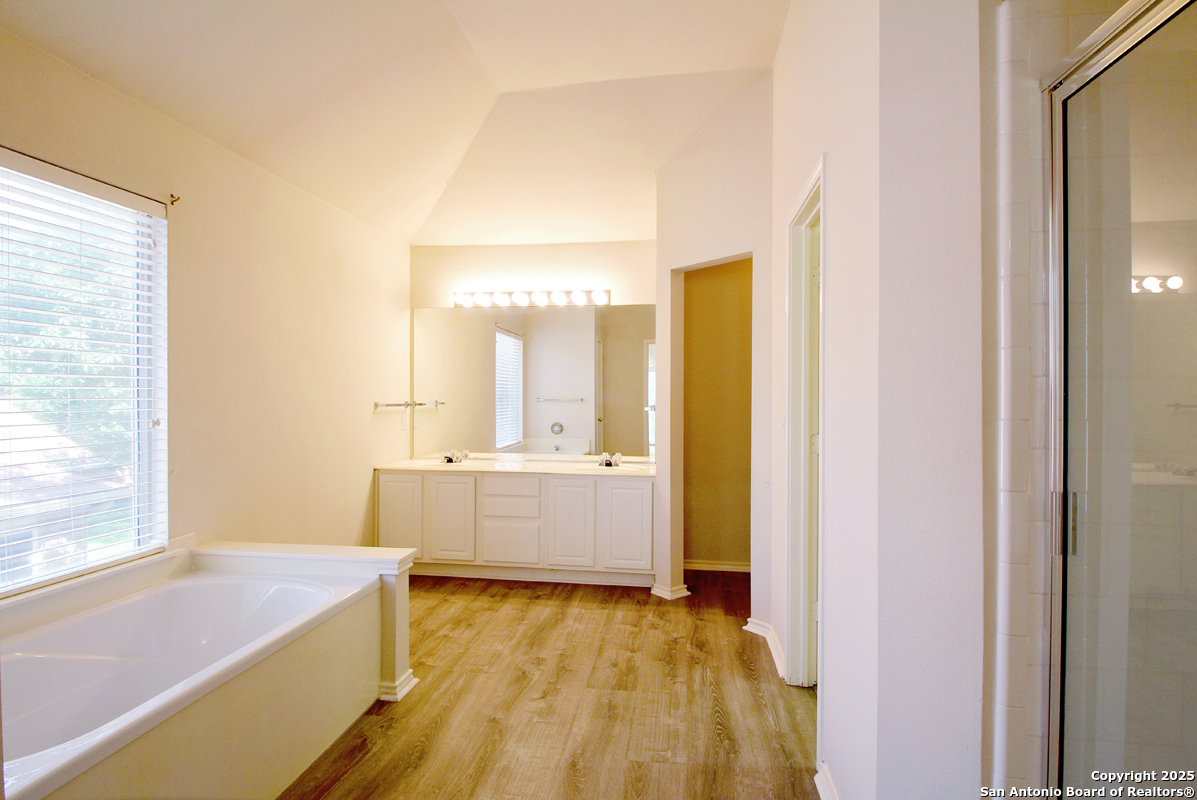 2703 Rio Brazos San Antonio, TX 78259 - Photo 21 of 34 a bathroom with a bathtub sink and mirror