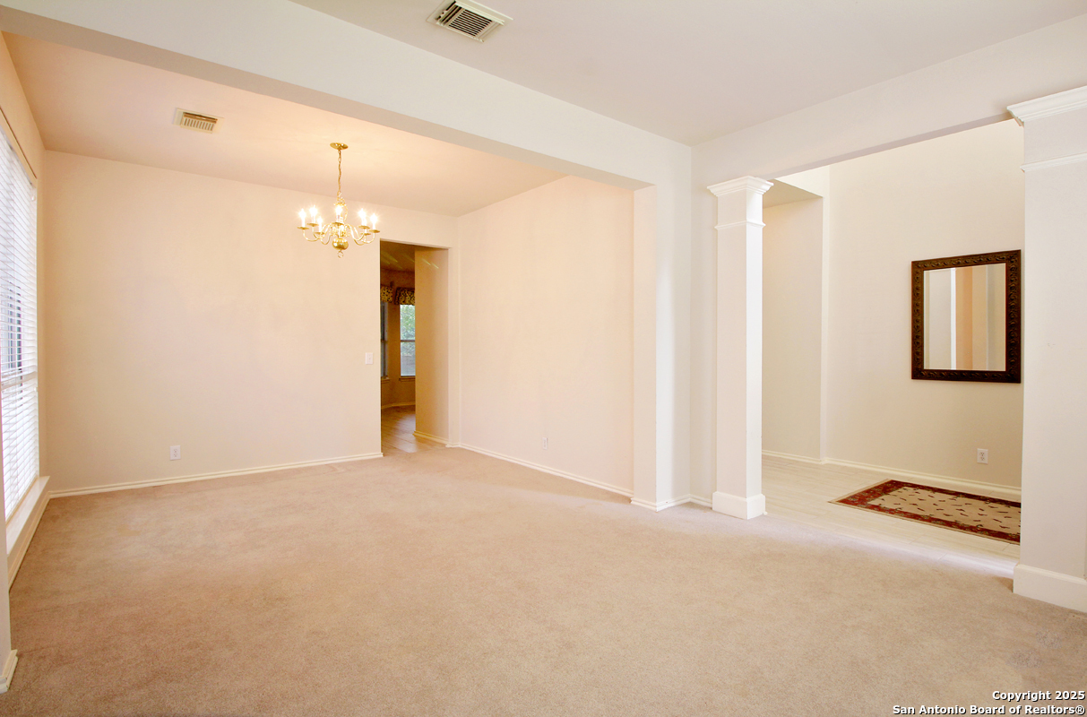 2703 Rio Brazos San Antonio, TX 78259 - Photo 5 of 34 an empty room with chandelier fan and windows
