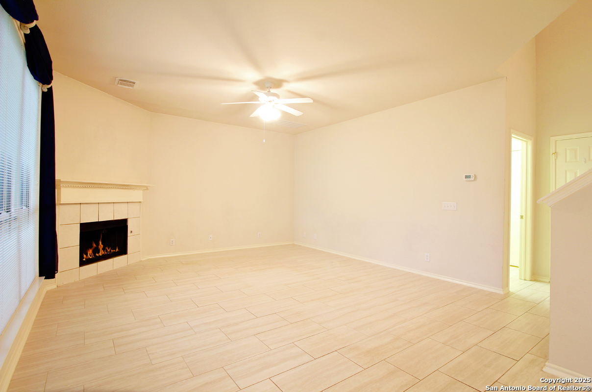 2703 Rio Brazos San Antonio, TX 78259 - Photo 9 of 34 a view of empty room with fan and a fireplace