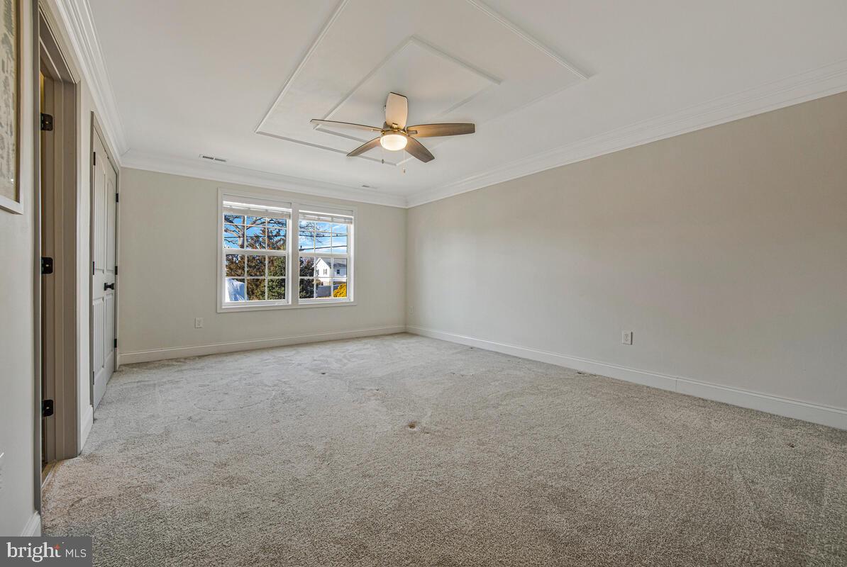 941 8th Street Pasadena, MD 21122 - Photo 21 of 41 an empty room with windows and ceiling fan