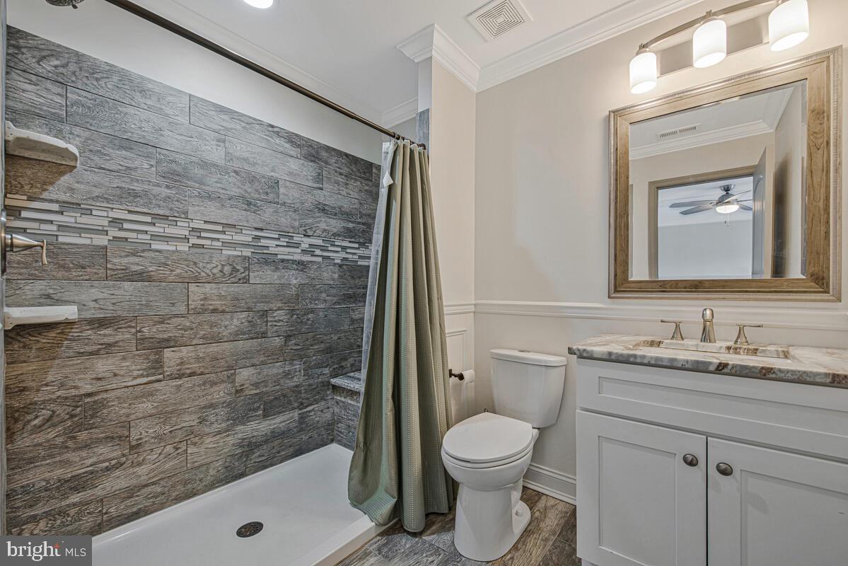941 8th Street Pasadena, MD 21122 - Photo 24 of 41 a bathroom with a sink a toilet and shower
