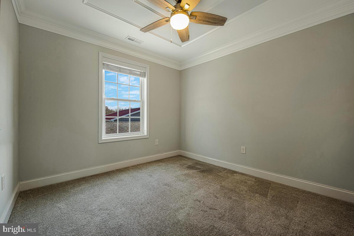 941 8th Street Pasadena, MD 21122 - Photo 28 of 41 an empty room with a window and a fan