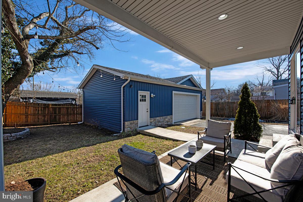 941 8th Street Pasadena, MD 21122 - Photo 38 of 41 a backyard of a house with barbeque oven table and chairs