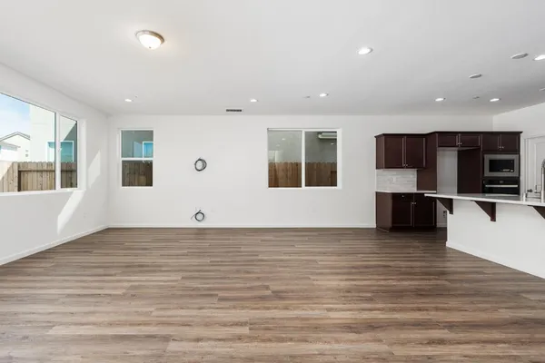 a view of a kitchen with an empty space and a window