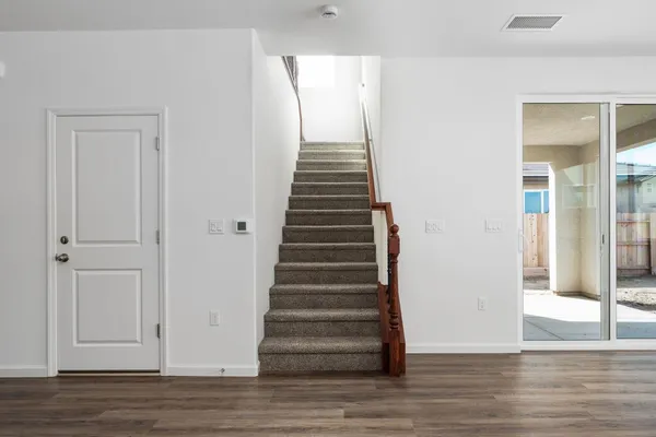 a view of an entryway with wooden floor