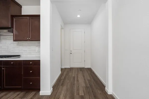 a view of a kitchen from the hallway