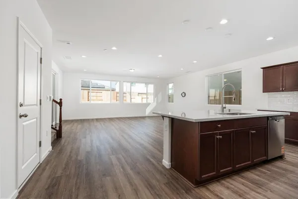 a view of a kitchen cabinets a sink and wooden floor