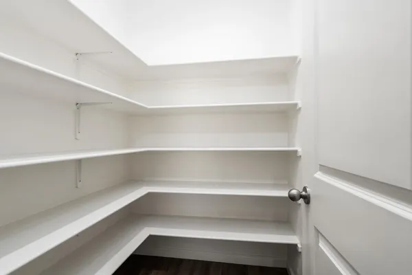 a view of walk in closet with empty racks