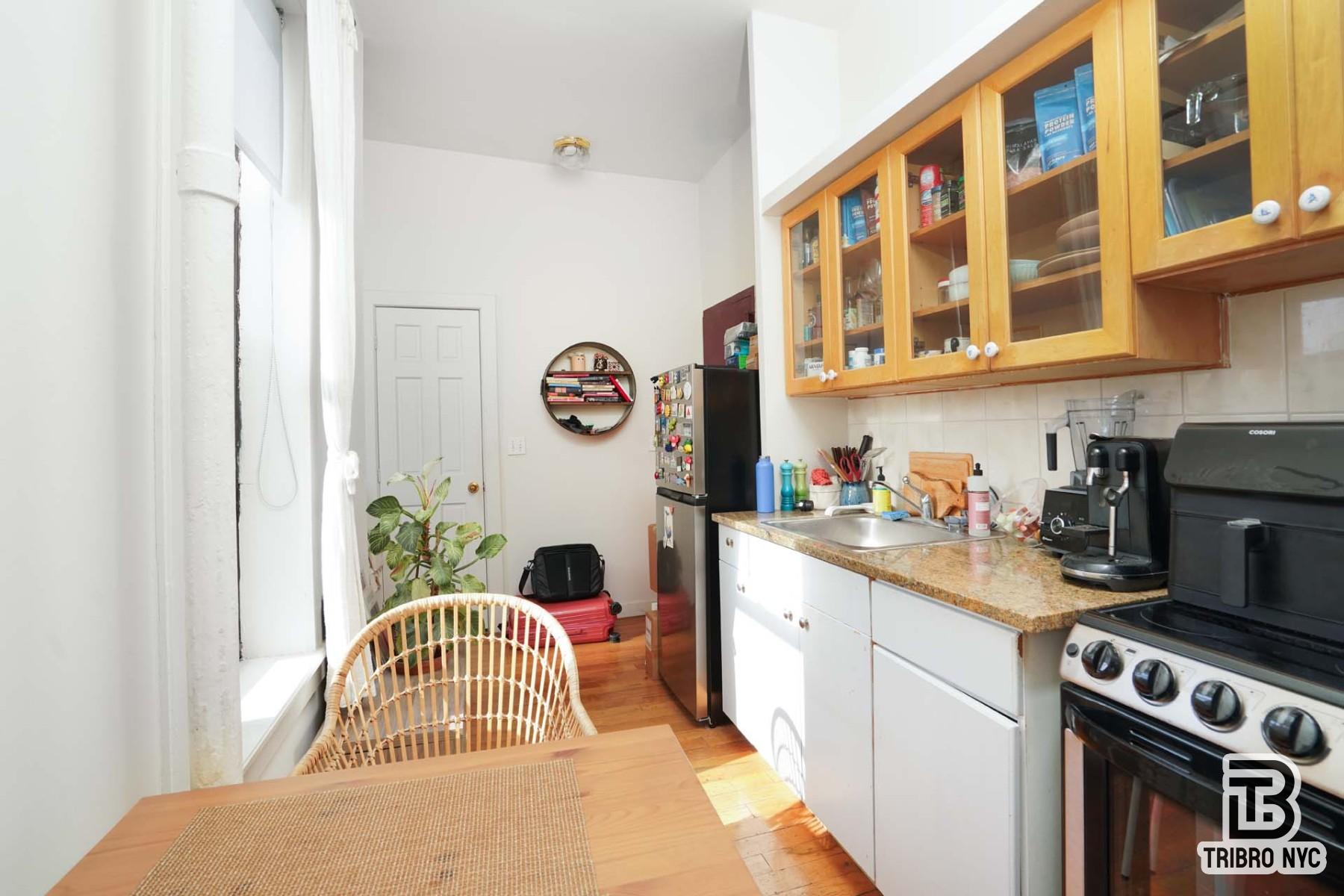 301 West 20th Street, Unit 2A Manhattan, NY 10011 - Photo 2 of 6 a kitchen with stainless steel appliances granite countertop a stove a sink and a refrigerator
