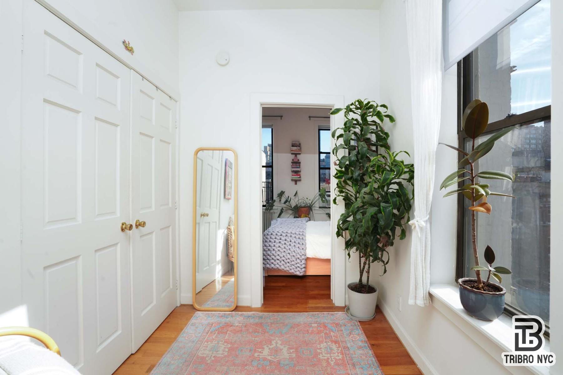 301 West 20th Street, Unit 2A Manhattan, NY 10011 - Photo 4 of 6 a living room with furniture and a potted plant