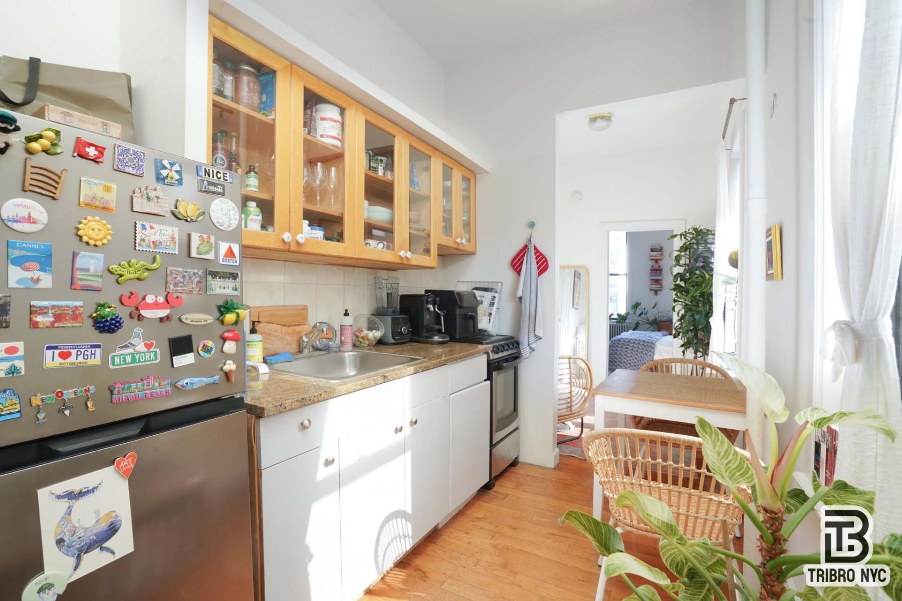 301 West 20th Street, Unit 2A Manhattan, NY 10011 - Photo 6 of 6 a kitchen with stainless steel appliances a sink and a wooden floor