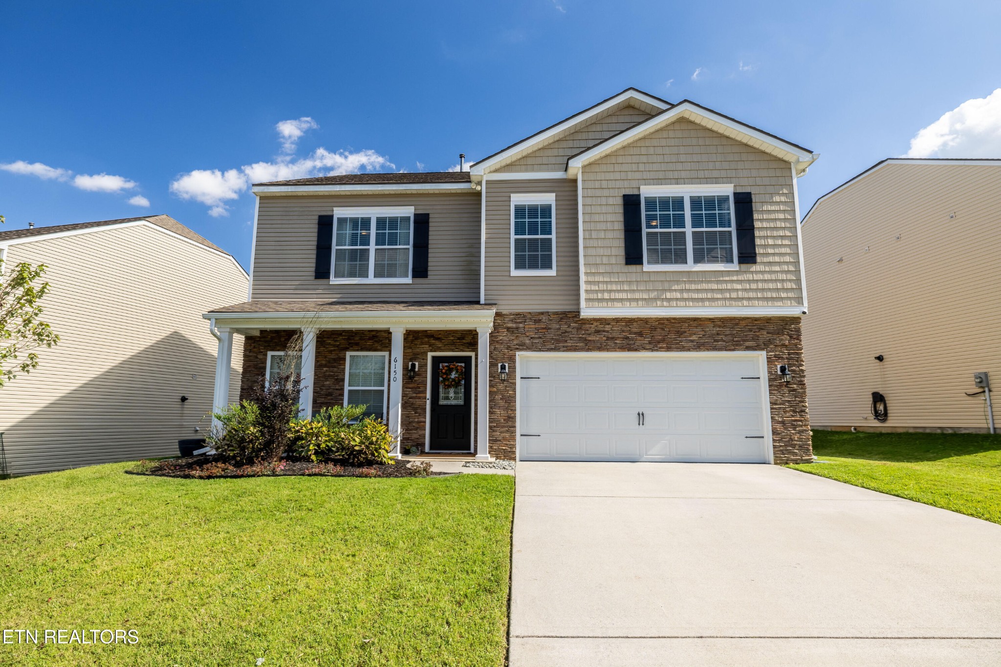 6150 Pembridge Road Knoxville, TN 37912 - Photo 1 of 34 a front view of a house with a yard and garage