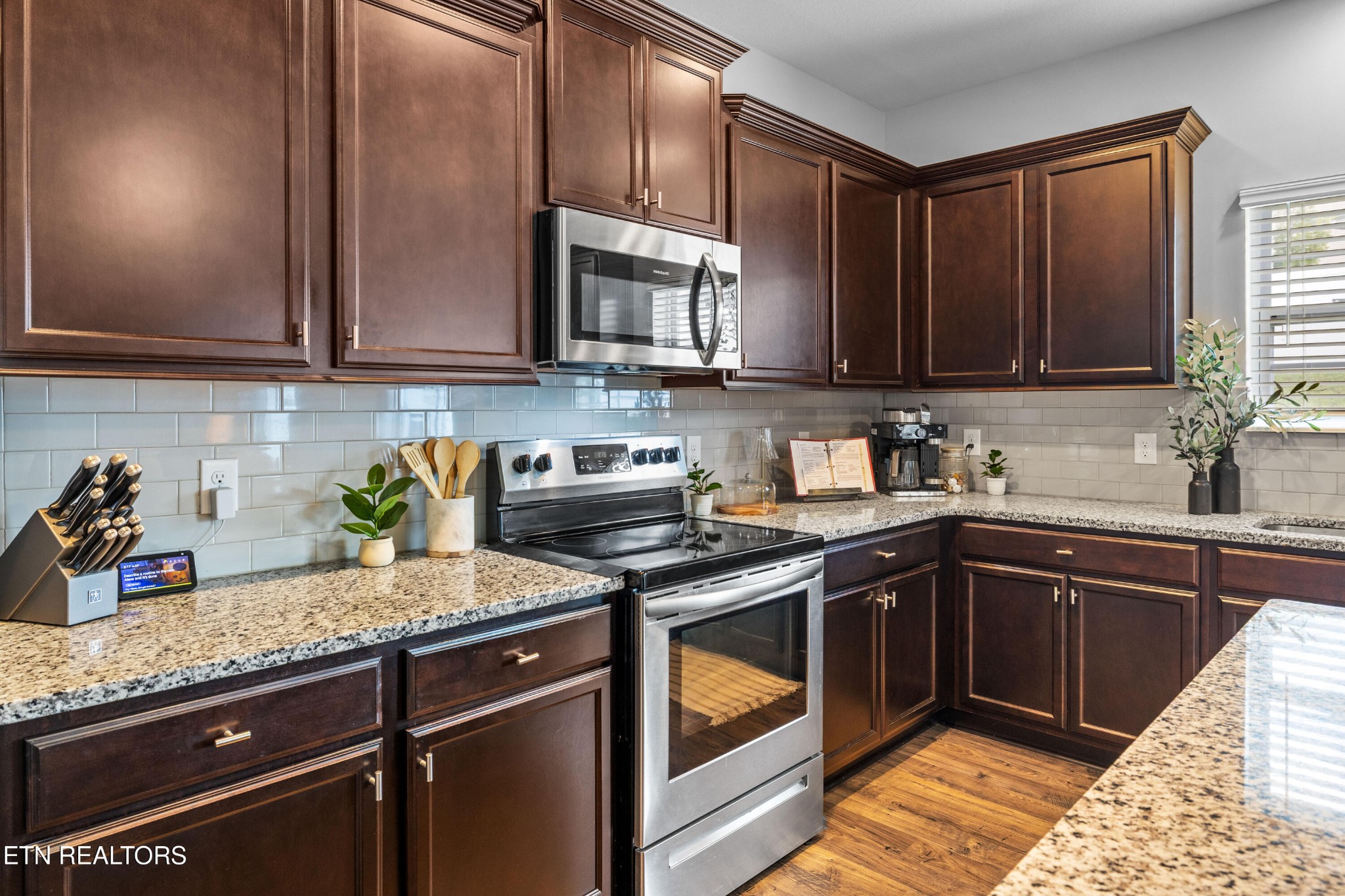 6150 Pembridge Road Knoxville, TN 37912 - Photo 12 of 34 a kitchen with granite countertop a sink stainless steel appliances and cabinets