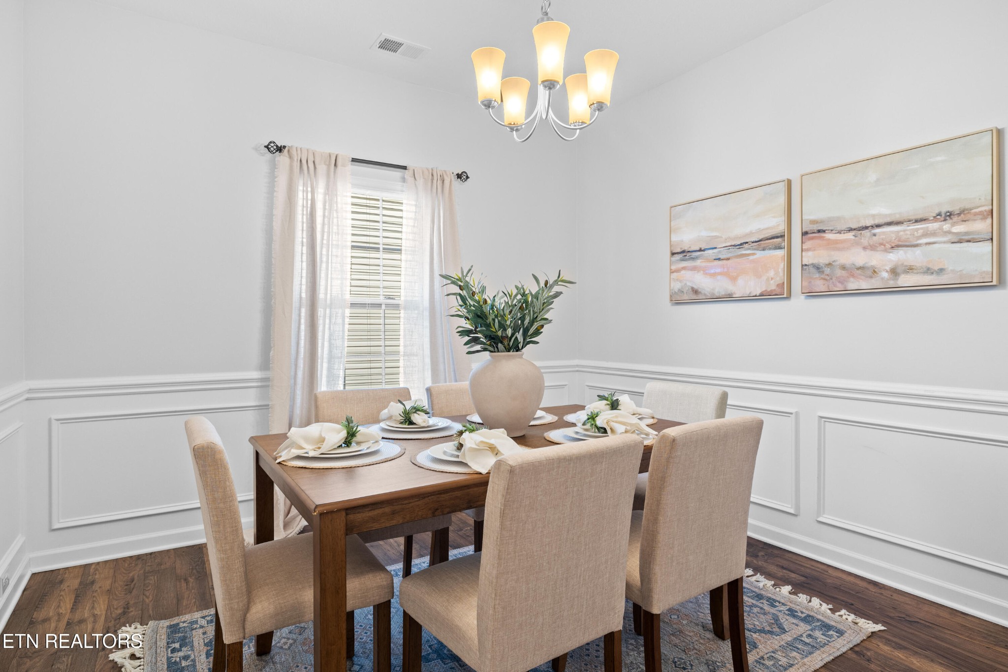 6150 Pembridge Road Knoxville, TN 37912 - Photo 15 of 34 a view of a dining room with furniture a chandelier and wooden floor