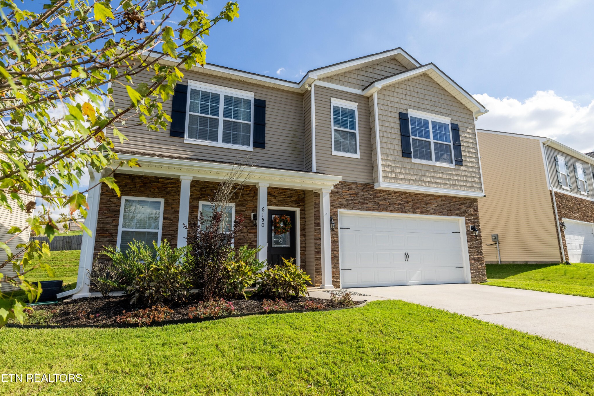 6150 Pembridge Road Knoxville, TN 37912 - Photo 2 of 34 a front view of a house with a yard and garage