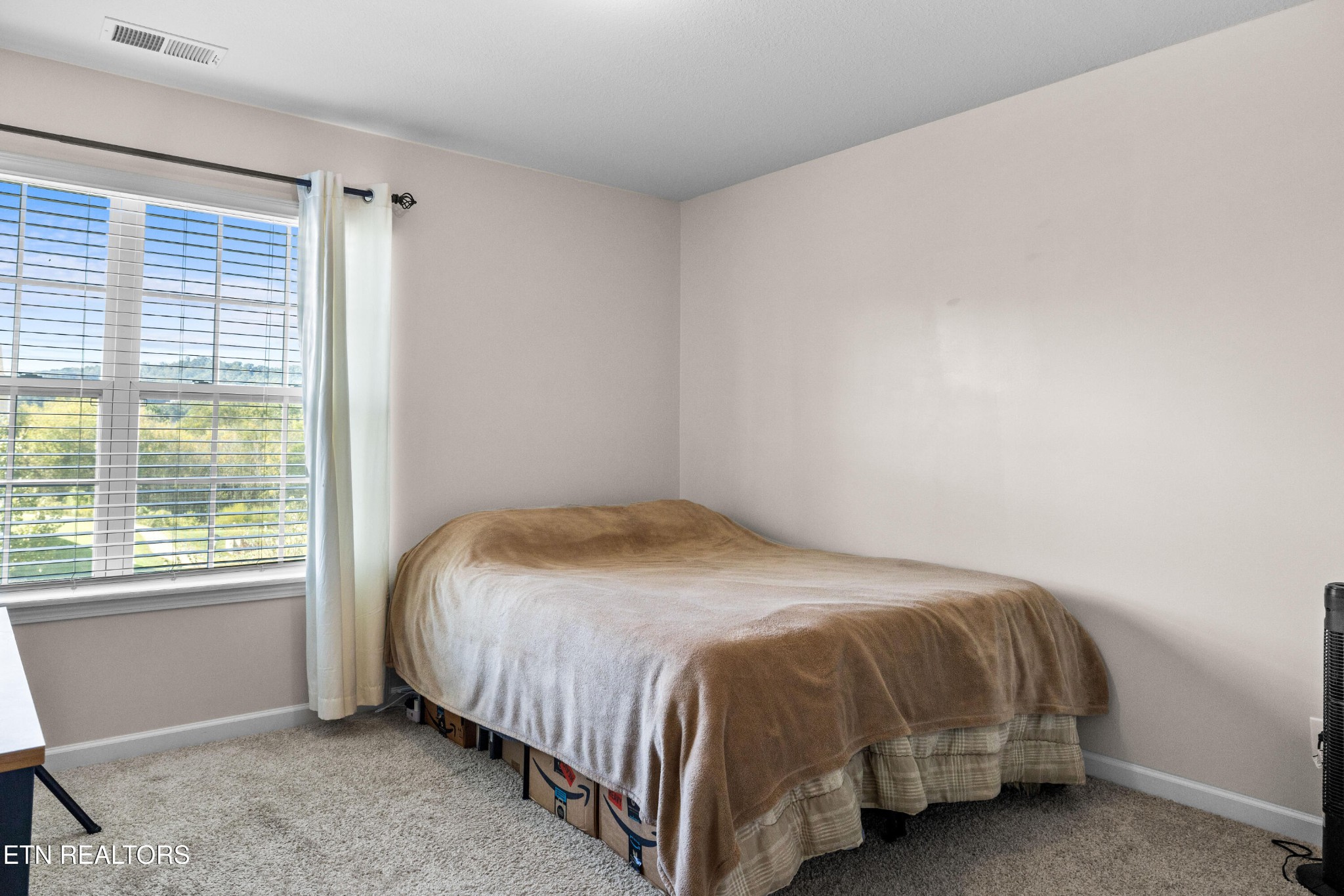 6150 Pembridge Road Knoxville, TN 37912 - Photo 30 of 34 a bed sitting in a bedroom next to a window