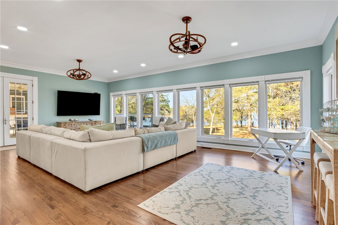 1133 Elrod Ferry Road Hartwell, GA 30643 - Photo 18 of 46 This airy living space features expansive windows and rich wood floors, offering serene views.