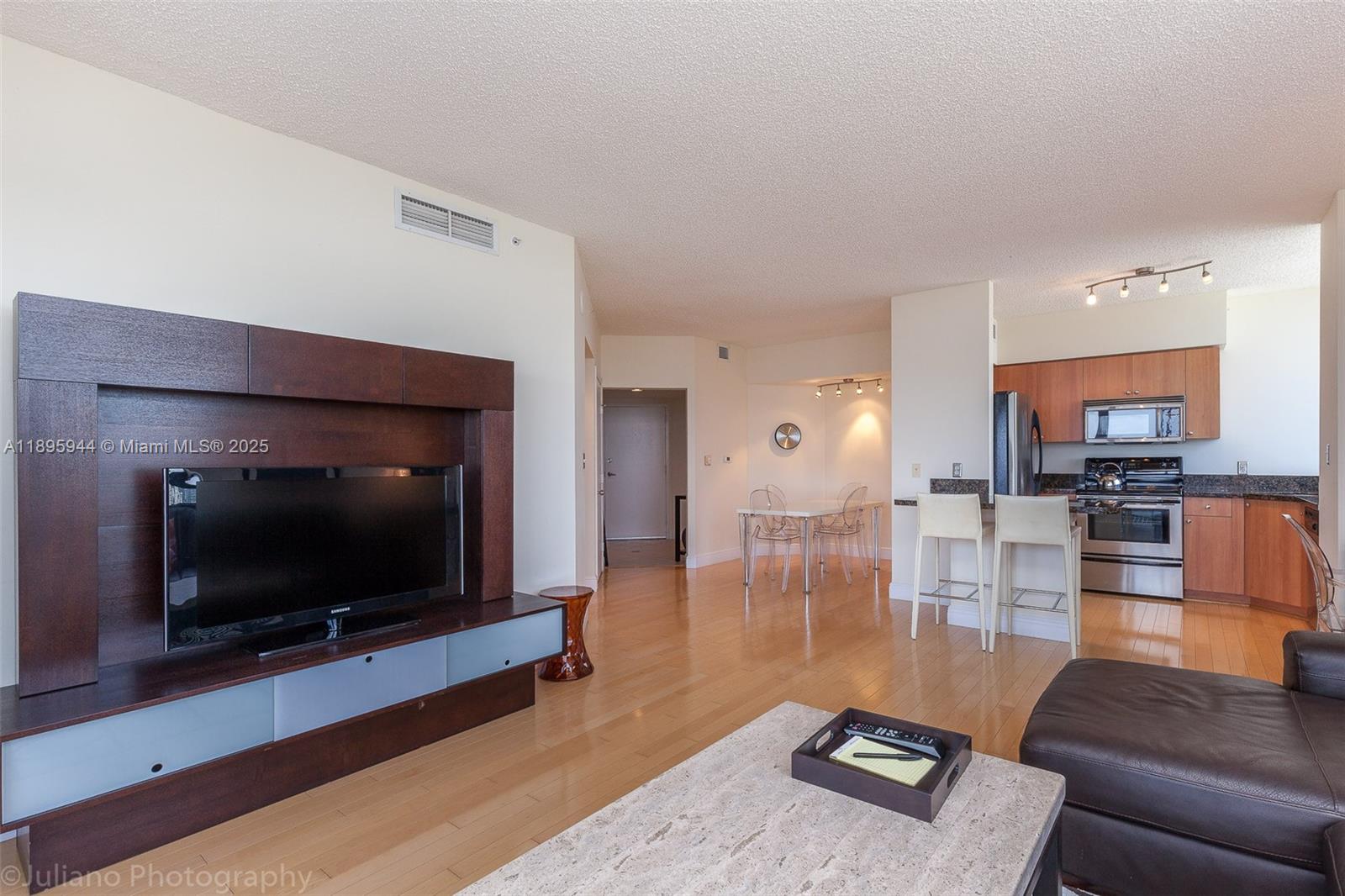 1330 West Avenue, Unit 1613 Miami Beach, FL 33139 - Photo 2 of 20 a living room with furniture and a flat screen tv