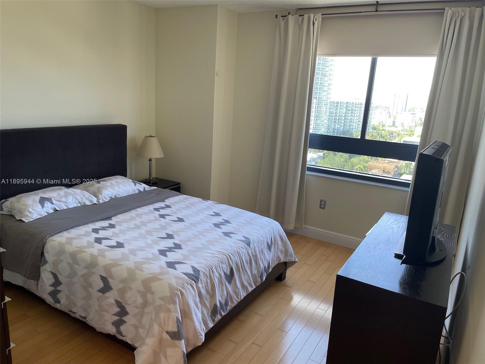 1330 West Avenue, Unit 1613 Miami Beach, FL 33139 - Photo 4 of 20 a bedroom with a bed and window