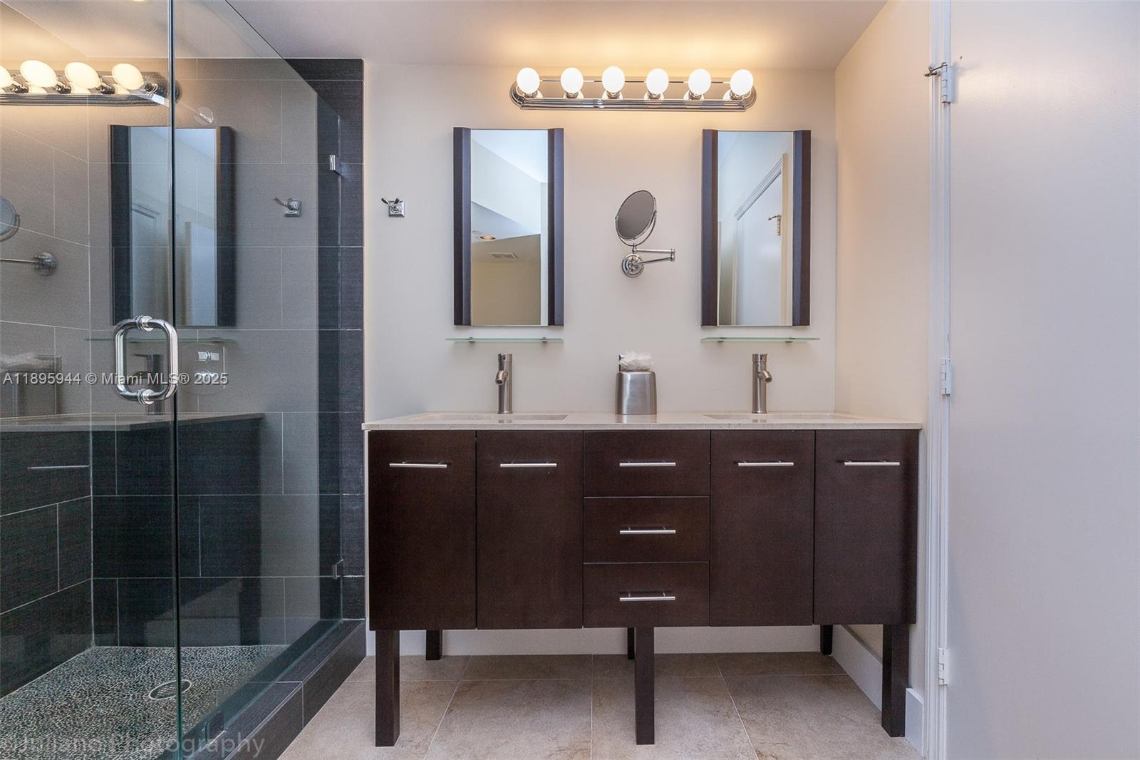 1330 West Avenue, Unit 1613 Miami Beach, FL 33139 - Photo 5 of 20 a bathroom with a double vanity sink and a mirror
