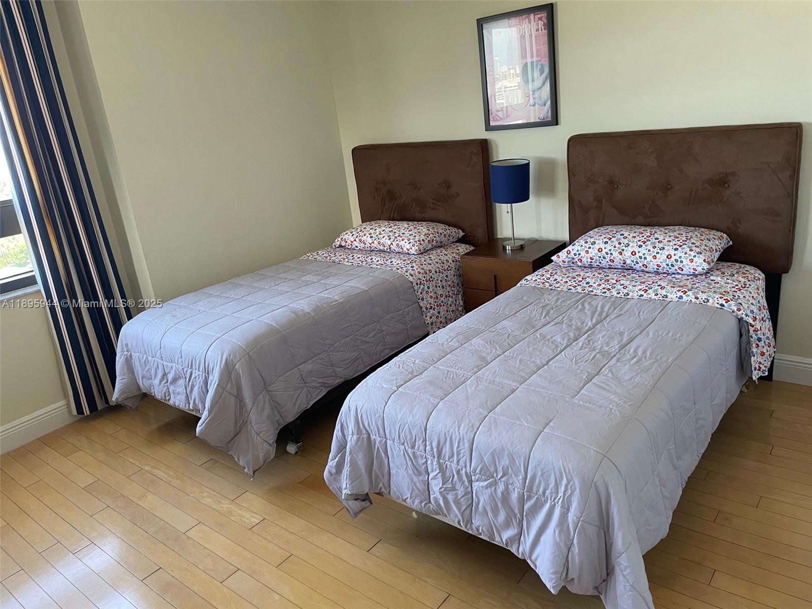 1330 West Avenue, Unit 1613 Miami Beach, FL 33139 - Photo 7 of 20 a bedroom with two beds and painting on the wall