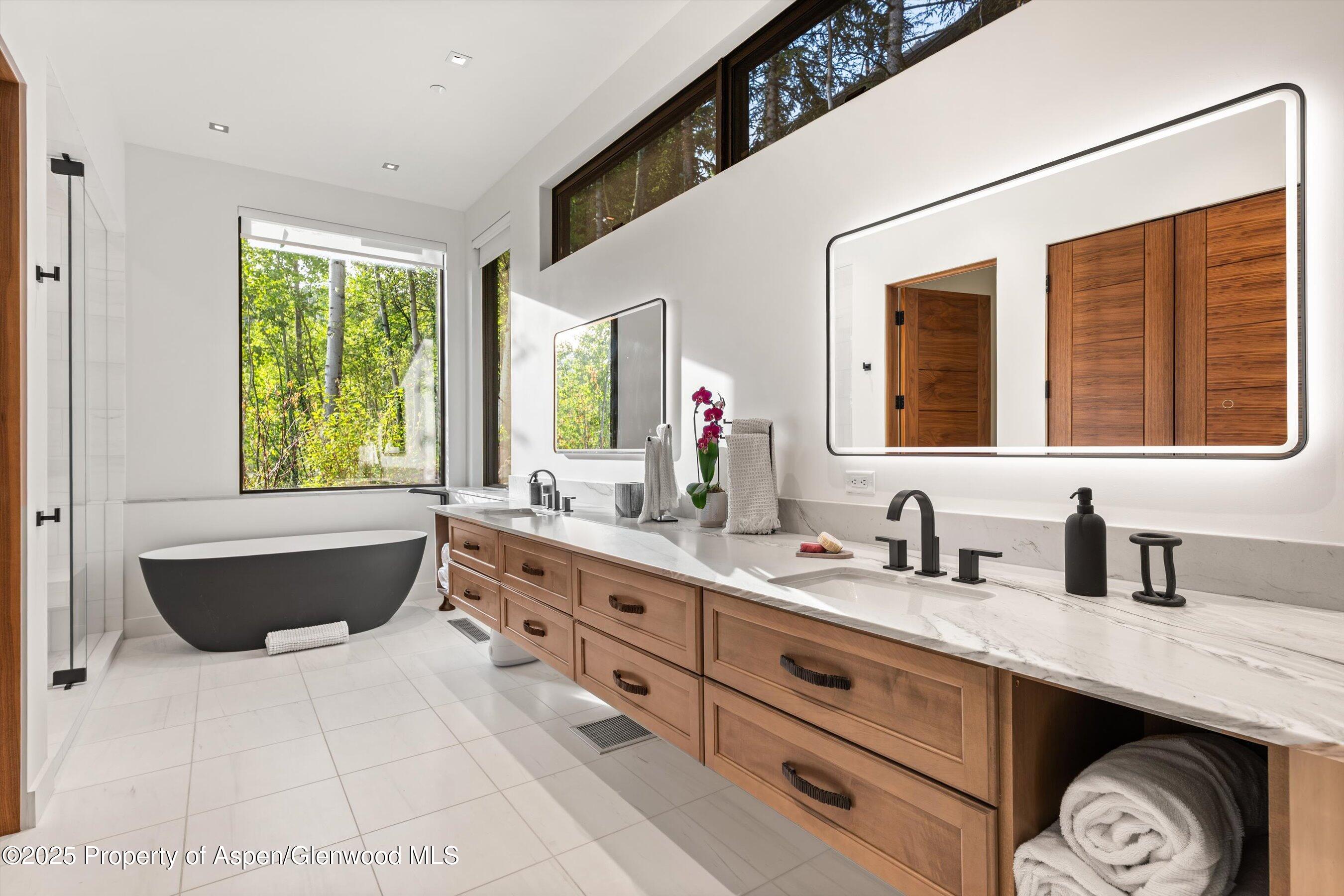 1234 Wood Road Snowmass Village, CO 81615 - Photo 41 of 66 a bathroom with a tub sink and window