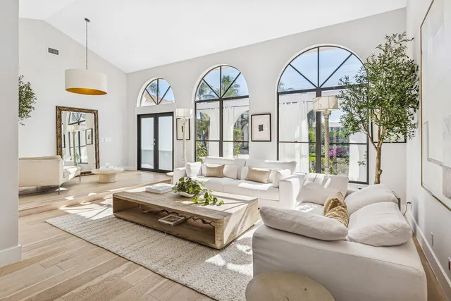 a living room with patio furniture and a large window