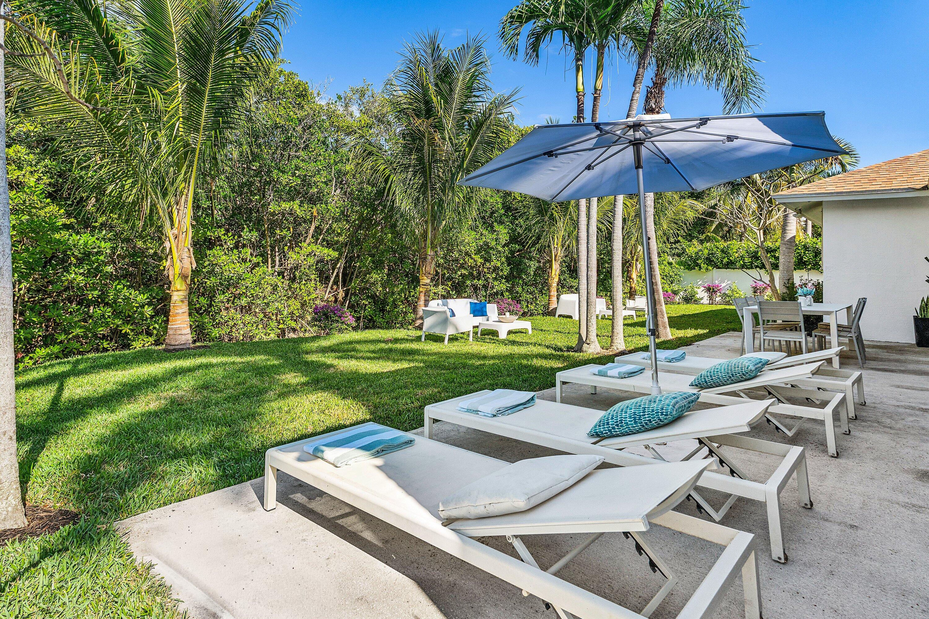 48 Harbour Drive North Ocean Ridge, FL 33435 - Photo 18 of 25 a view of backyard with outdoor seating and trees
