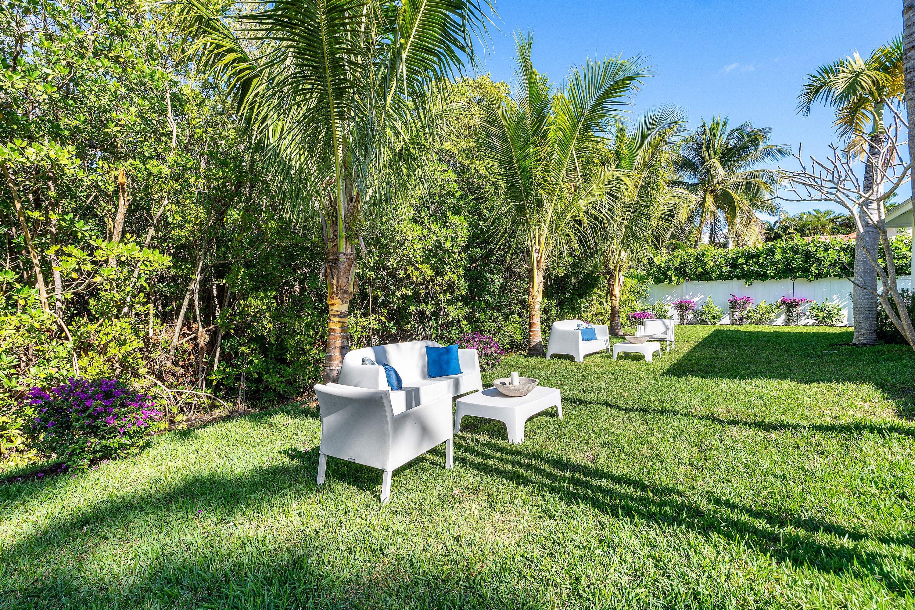 48 Harbour Drive North Ocean Ridge, FL 33435 - Photo 19 of 25 a view of a chair and table in a garden