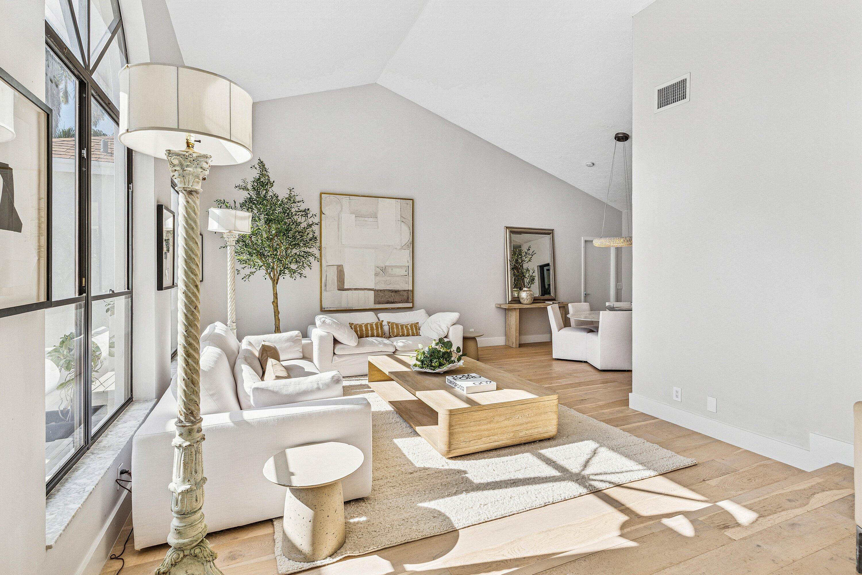 48 Harbour Drive North Ocean Ridge, FL 33435 - Photo 3 of 25 a living room with furniture and a chandelier
