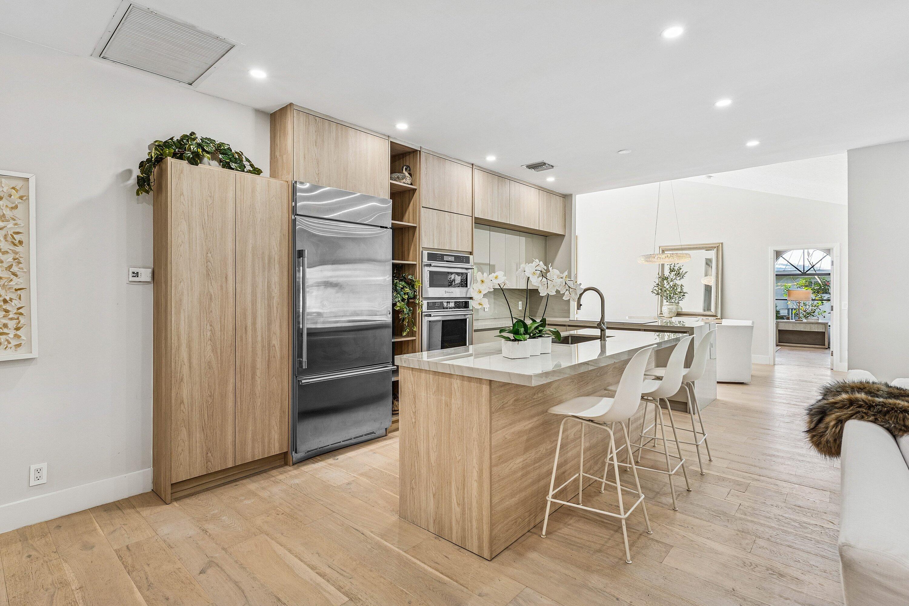 48 Harbour Drive North Ocean Ridge, FL 33435 - Photo 7 of 25 a kitchen with stainless steel appliances granite countertop a refrigerator and a stove top oven