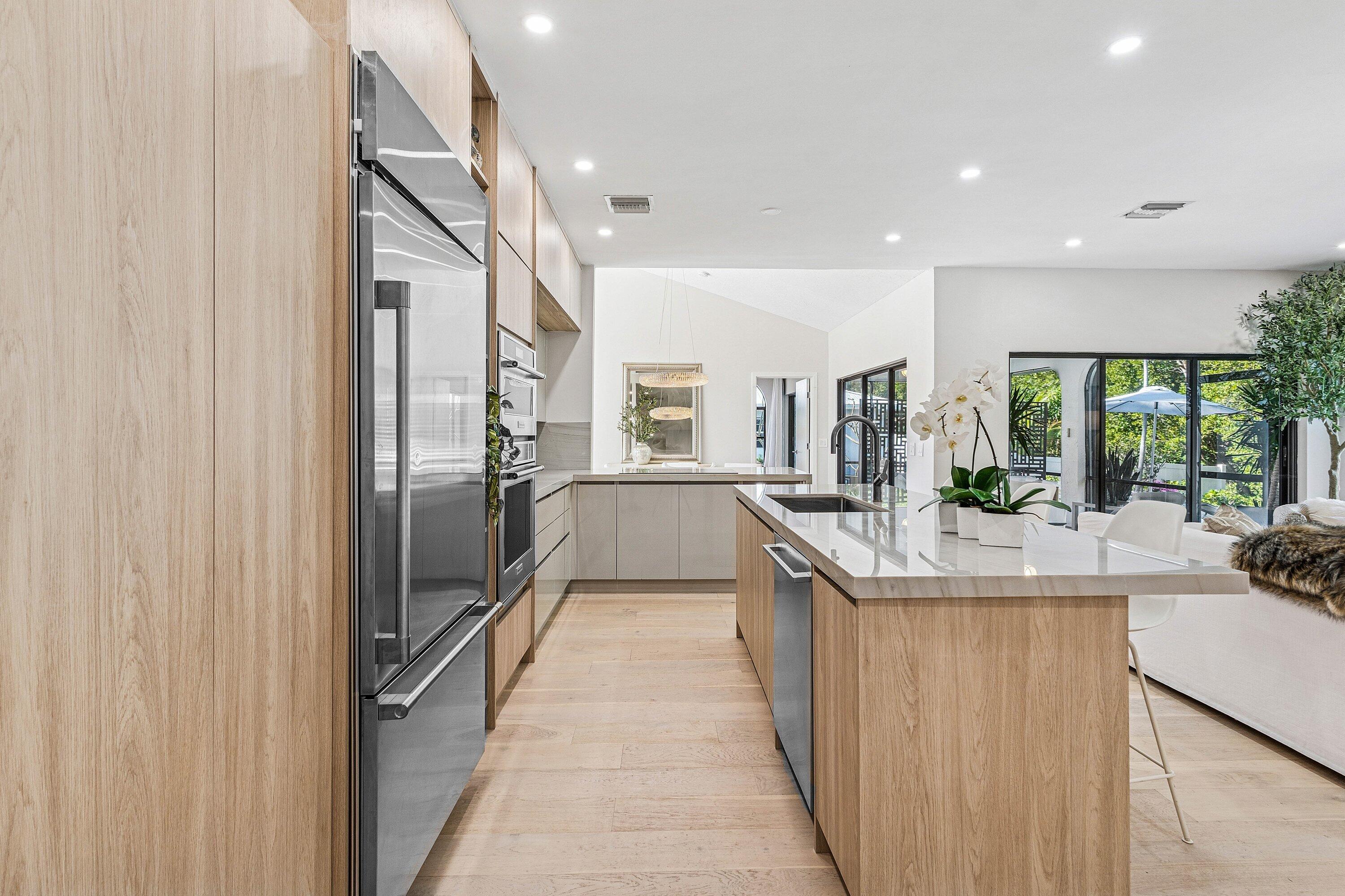 48 Harbour Drive North Ocean Ridge, FL 33435 - Photo 8 of 25 a kitchen with stainless steel appliances granite countertop a sink and a refrigerator