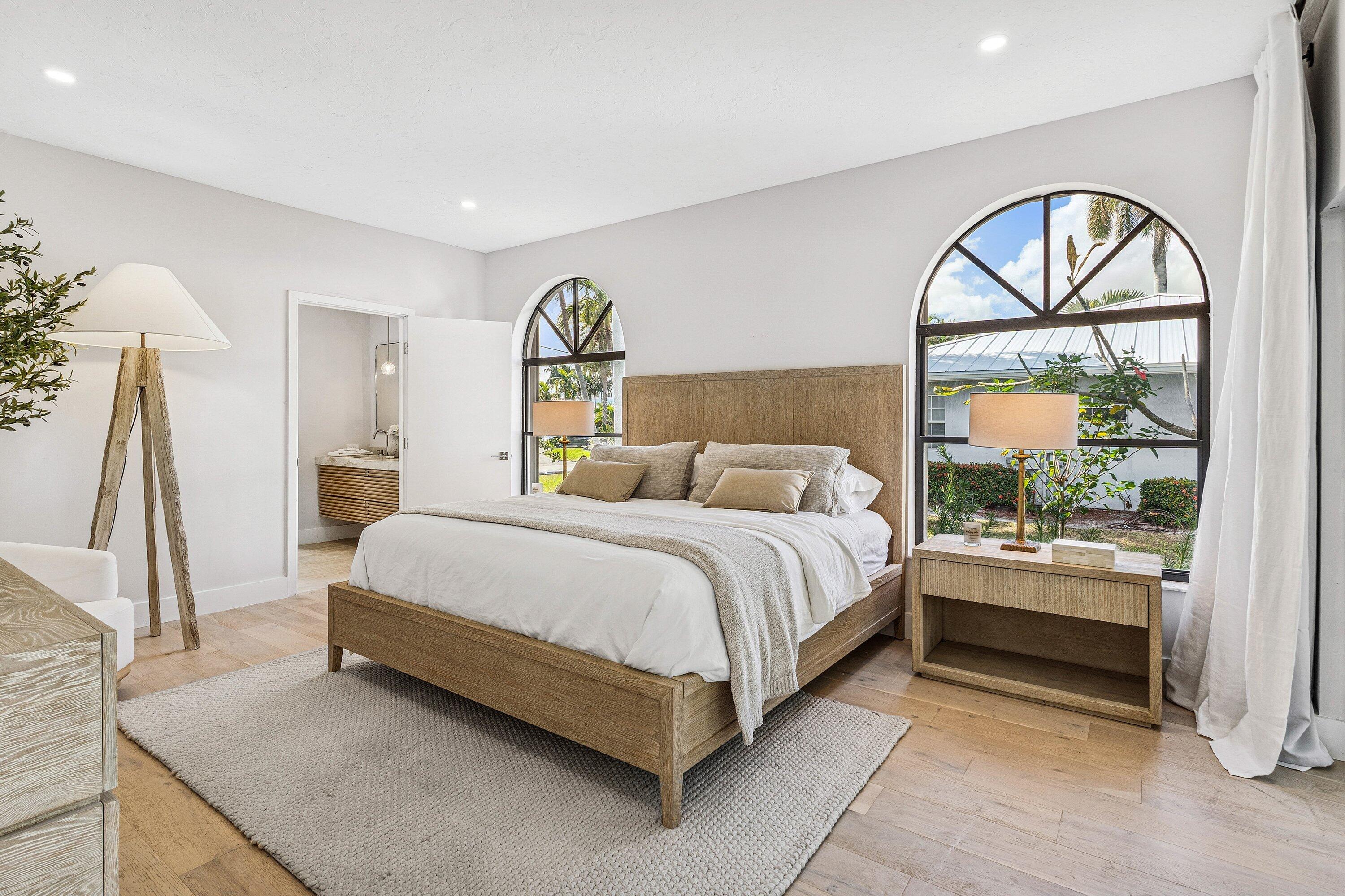 48 Harbour Drive North Ocean Ridge, FL 33435 - Photo 9 of 25 a spacious bedroom with a bed and a painting on the wall