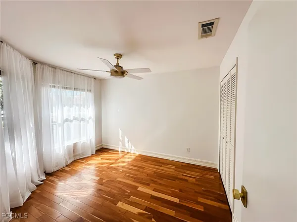 a view of a room with a ceiling fan