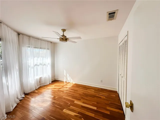 a view of a room with a ceiling fan